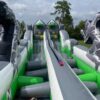 A green and white Bungee Run with a dragon on it.