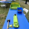 A blue table with a Frog Flipper Game on it, featuring a Frog Flipper Game.
