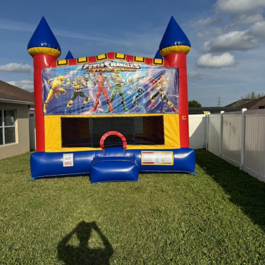 Power Rangers inflatable bounce house in backyard