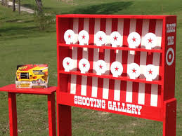 A target shooting gallery set up in a field featuring a Tic Tac Toe Game.