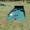 A Mini Golf with a tee and a ball.