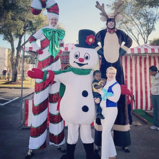 A group of people dressed up as Christmas Characters.