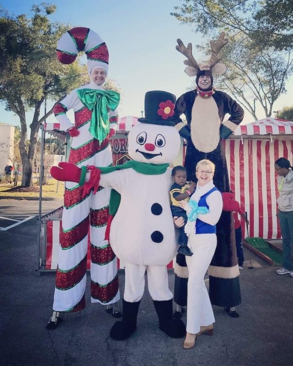 A group of people dressed up as Christmas Characters.