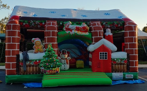 A Christmas North Pole Inflatable bounce house in a parking lot.