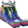 A rainbow colored Unicorn Slide shaped like a castle, featuring a unicorn motif.