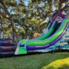 A Halloween-themed Halloween 19 Foot Slide in a grassy area.
